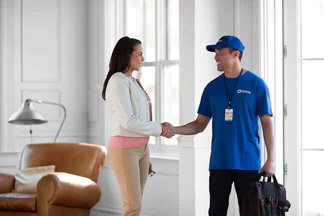 handyman shaking hands with homeowner after completing job